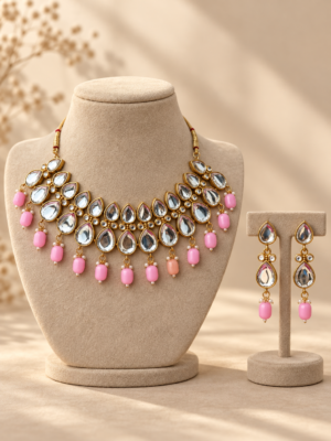 Ameesha light pink Kundan necklace and matching drop earrings with teardrop stones and pink bead drops on beige stands