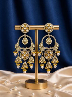 Sonakshi yellow Kundan chandbali earrings with pearl drops and hanging motifs.