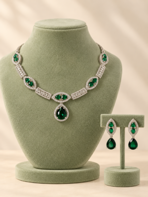 Jessica dark green American Diamond necklace with a teardrop pendant and matching drop earrings on a cream display bust