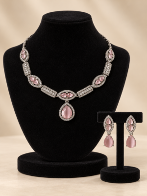 Jessica light pink American Diamond necklace with a teardrop pendant and matching drop earrings on a cream display bust
