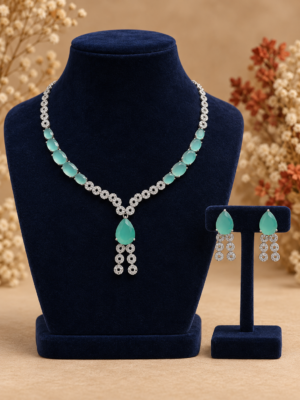 Riddhima mint green American diamond necklace set with mint green teardrop stones, floral detailing and matching drop earrings