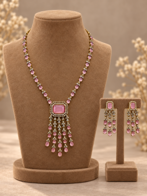 Sara light pink American diamond necklace and matching tassel-style earrings in mehendi polish displayed on a brown jewellery bust and stand