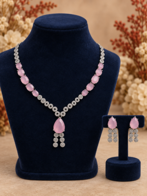Riddhima pink American diamond necklace set with pink teardrop stones, floral detailing and matching drop earrings