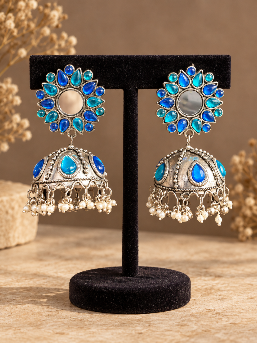 Pair of blue and turquoise oxidised jhumka earrings with circular mirror-detail tops and pearl-style drops
