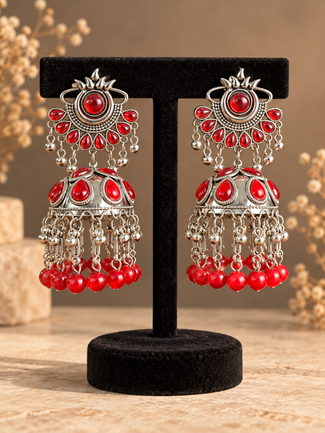 Pair of 10.5 cm red stone oxidised silver-tone jhumka earrings with decorated domes and hanging red bead drops