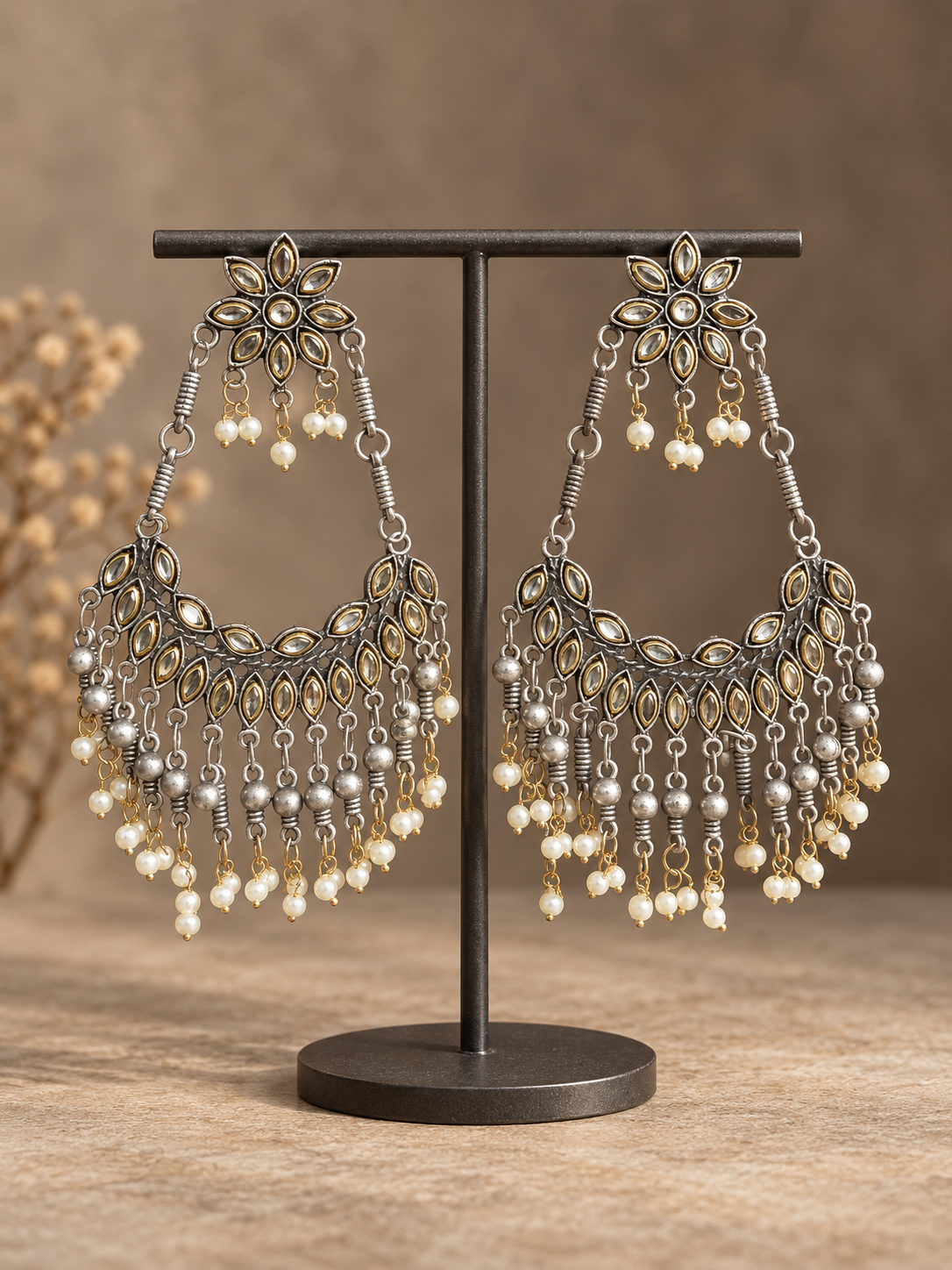 Pair of 12 cm oxidised floral chandbali earrings with reflective leaf details, silver-tone bead tassels and white pearl-style drops
