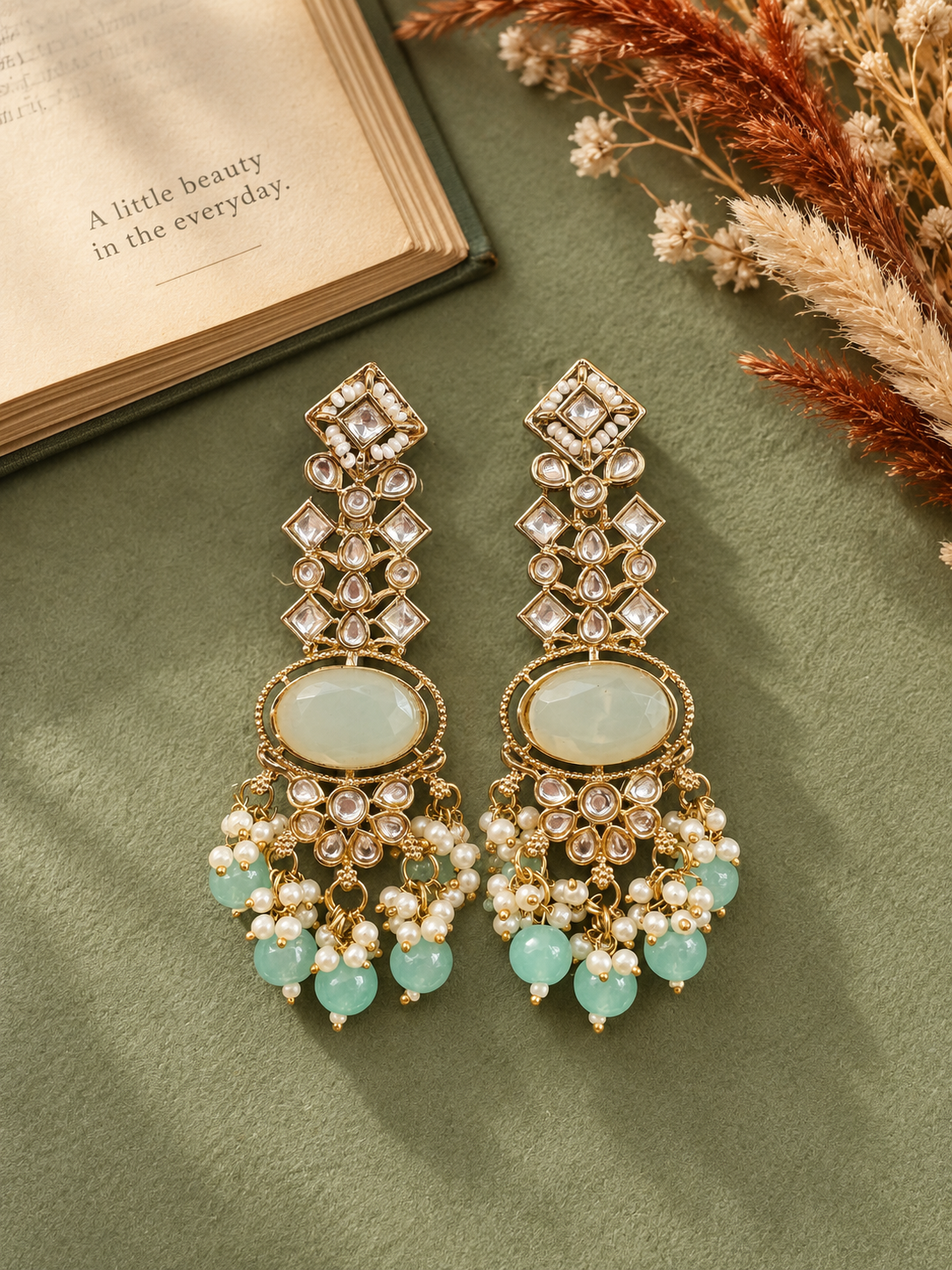 Saanvika light blue Kundan dangler earrings with geometric stones, oval centres, floral motifs and hanging beadsSaanvika light blue Kundan dangler earrings with geometric stones, oval centres, floral motifs and hanging beads
