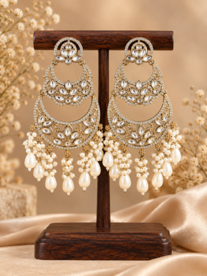Varnika white layered Kundan chandbali earrings with floral motifs, clear stone borders and cascading bead drops